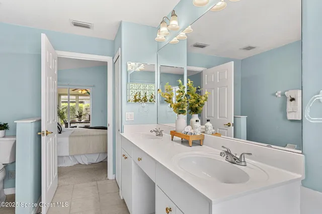 a bathroom with a sink vanity and a mirror