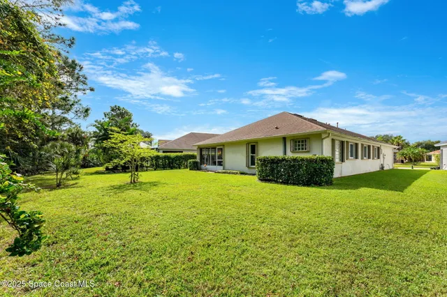 a yellow house with a yard