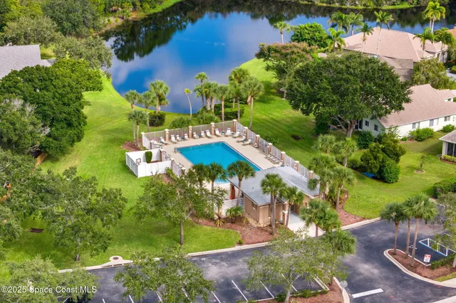 an aerial view of a house with yard swimming pool and outdoor seating