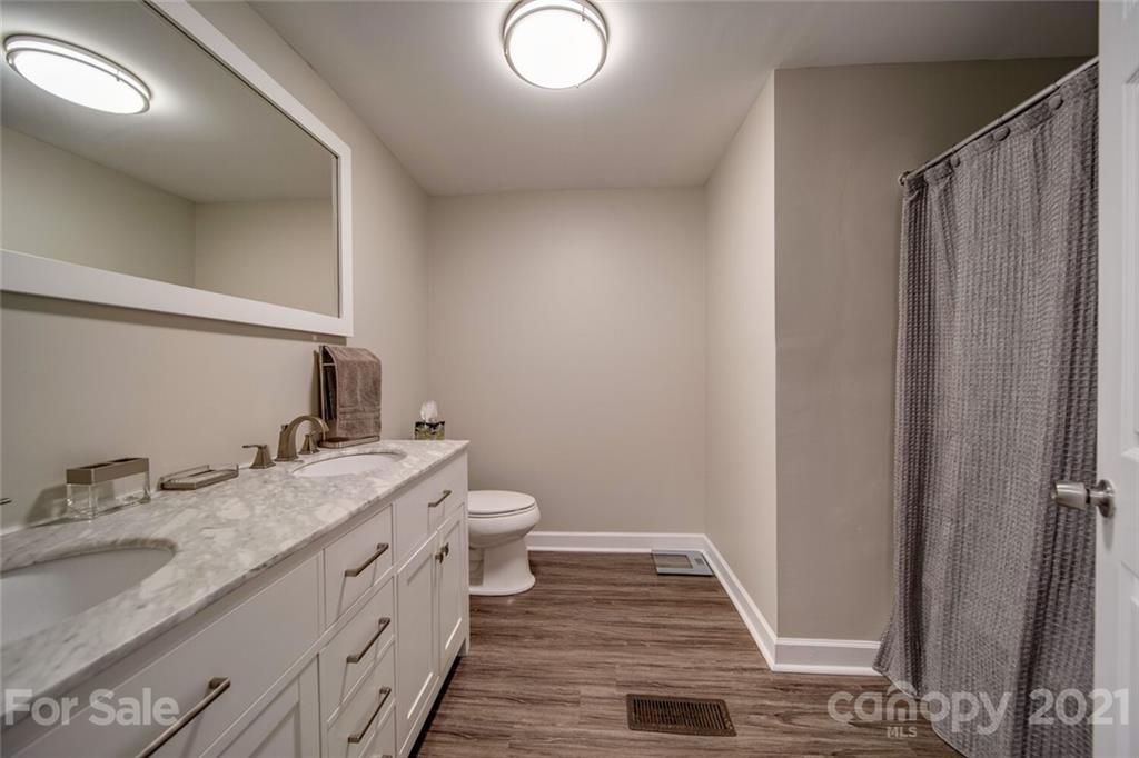 4414 Love Mill Road Monroe, NC 28110 - Photo 33 of 48 a bathroom with a granite countertop sink toilet and shower