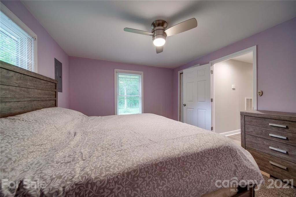4414 Love Mill Road Monroe, NC 28110 - Photo 34 of 48 a bedroom with a bed and a chandelier