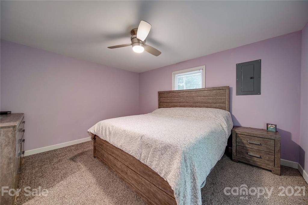 4414 Love Mill Road Monroe, NC 28110 - Photo 38 of 48 a bedroom with a bed and a chandelier