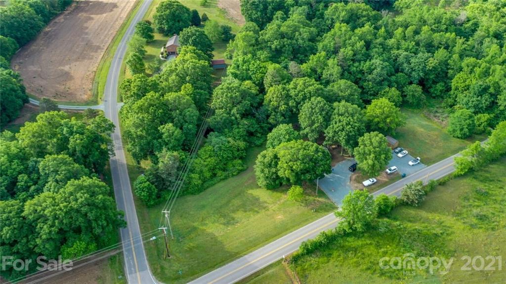 4414 Love Mill Road Monroe, NC 28110 - Photo 5 of 48 an aerial view of residential houses with outdoor space and trees