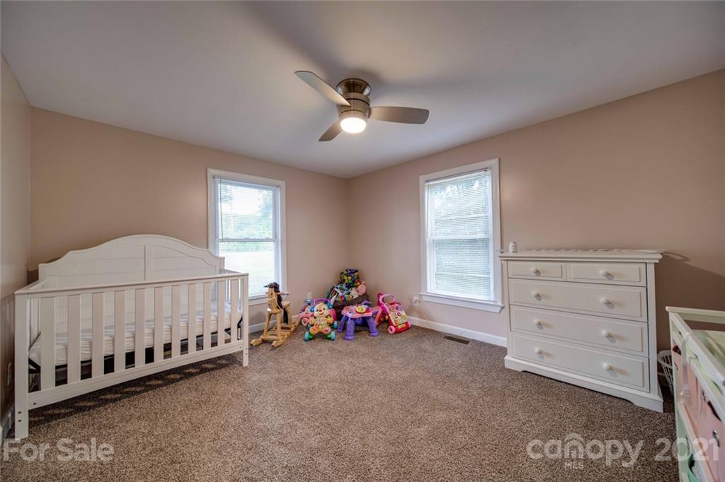 4414 Love Mill Road Monroe, NC 28110 - Photo 42 of 48 a bed room with a bed and a chair