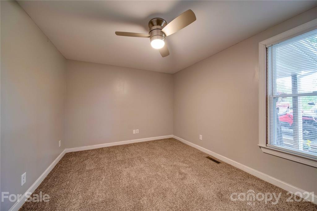 4414 Love Mill Road Monroe, NC 28110 - Photo 46 of 48 an empty room with windows and ceiling fan