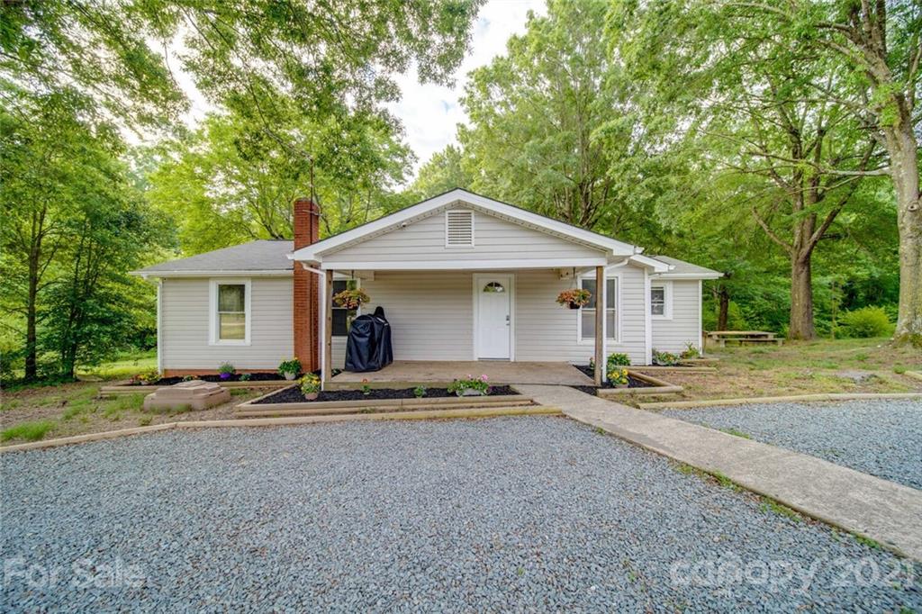 4414 Love Mill Road Monroe, NC 28110 - Photo 8 of 48 a front view of a house with garden