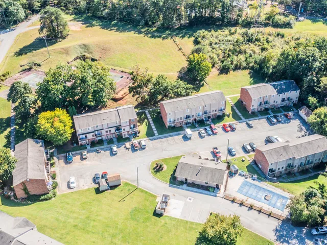 an aerial view of a house with yard swimming pool and outdoor seating