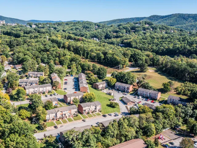 an aerial view of residential houses with outdoor space and street view