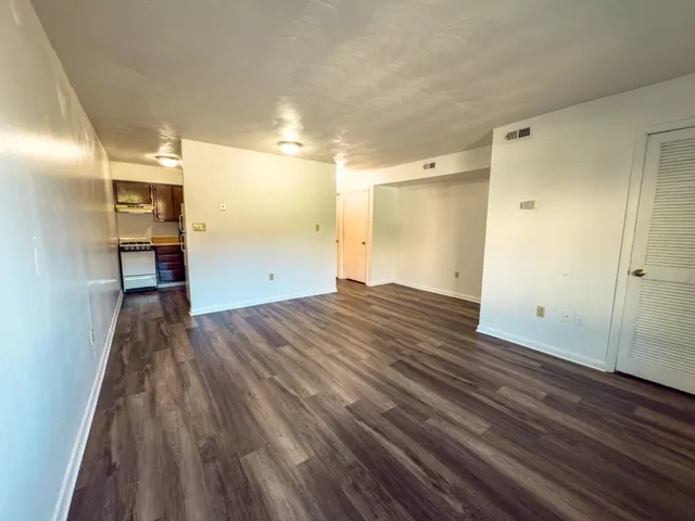 a view of a room with wooden floor