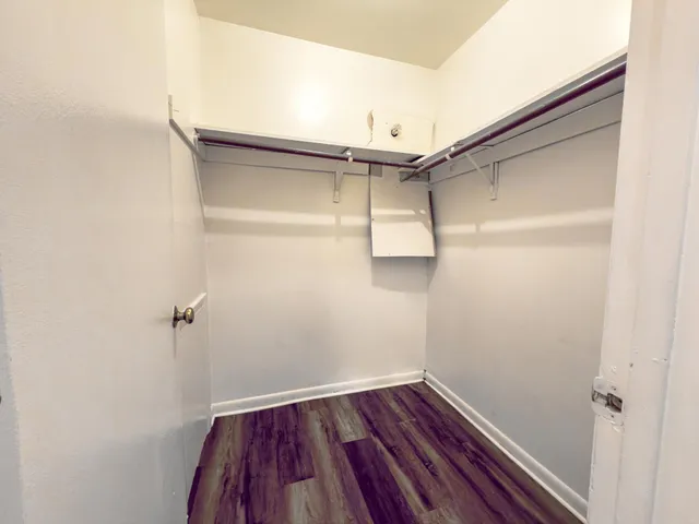 a view of a room with wooden floor