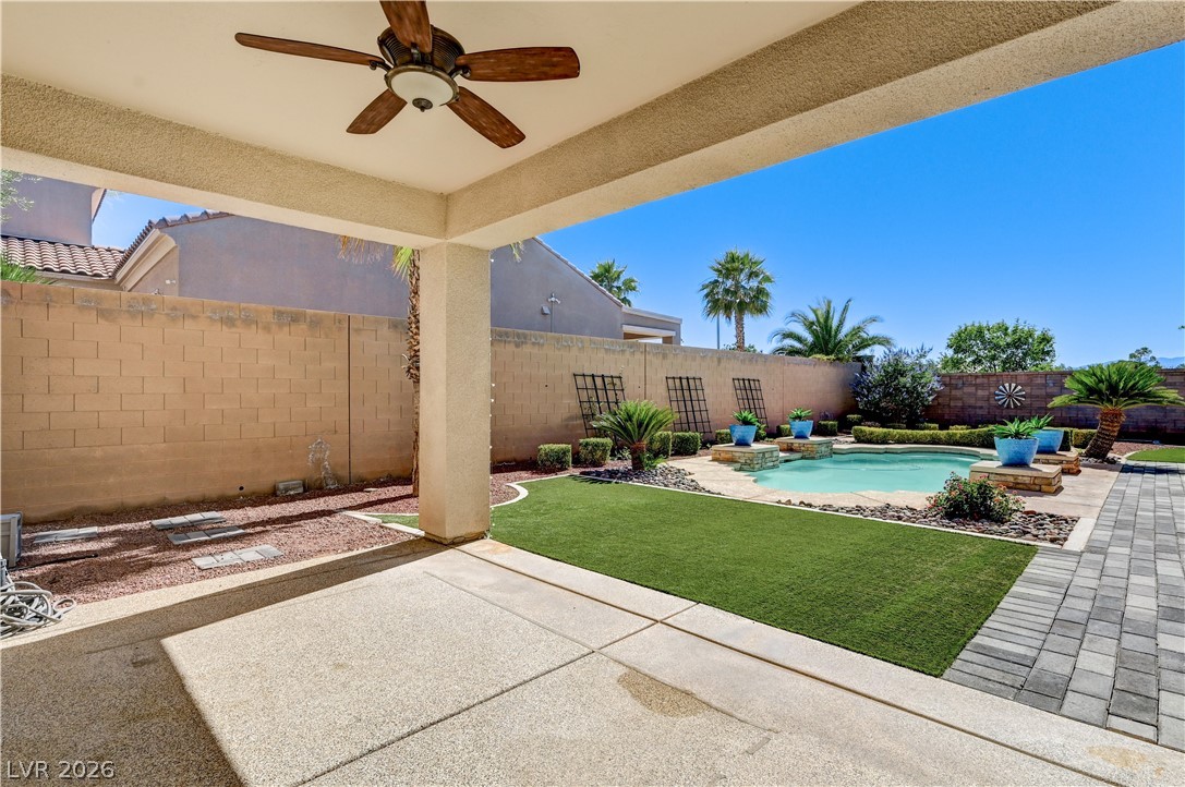 2793 Rosenhearty Drive Henderson, NV 89044 - Photo 63 of 85 An inviting backyard oasis offers a covered patio, artificial turf, and a sparkling pool perfect for relaxation.