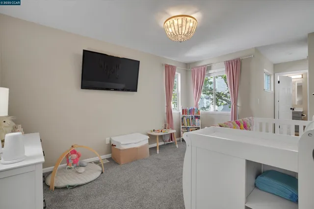 a view of a livingroom with an empty space and a window
