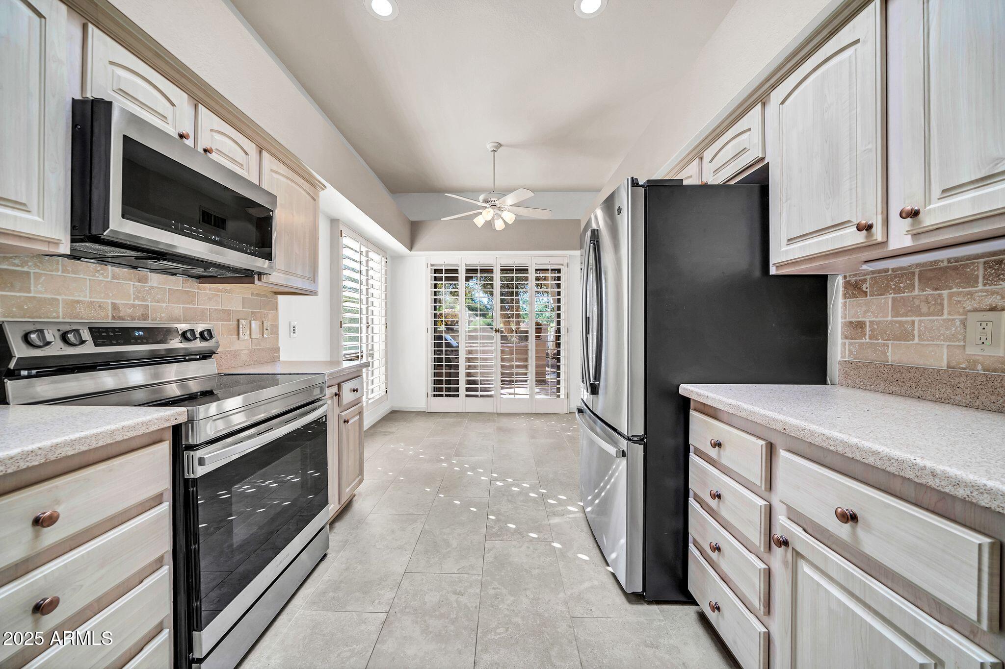 25515 Forest Road, Unit 13 Rio Verde, AZ 85263 - Photo 12 of 37 a kitchen with stainless steel appliances granite countertop a stove microwave and refrigerator