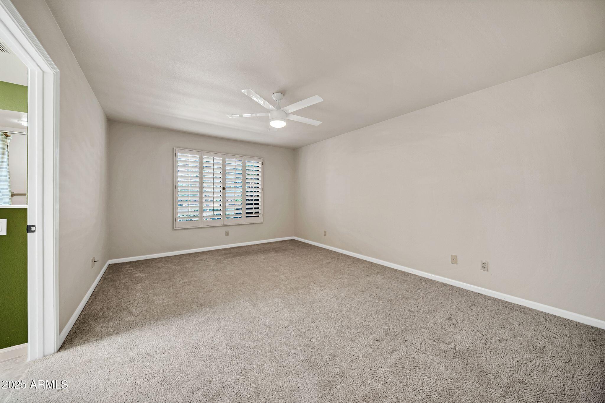 25515 Forest Road, Unit 13 Rio Verde, AZ 85263 - Photo 19 of 37 an empty room with windows and fan
