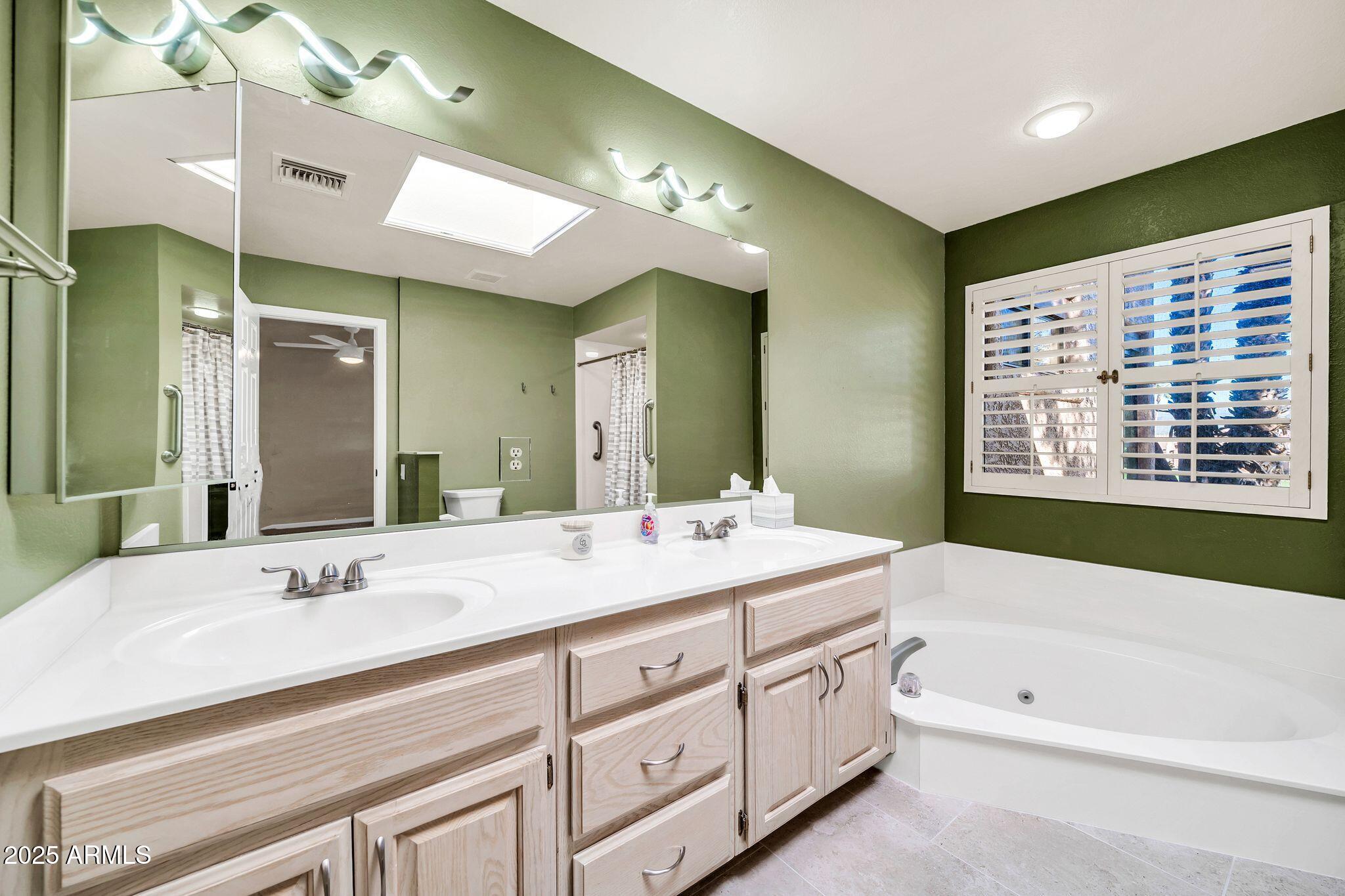 25515 Forest Road, Unit 13 Rio Verde, AZ 85263 - Photo 20 of 37 a spacious bathroom with a granite countertop sink a mirror a bathtub and next to a window