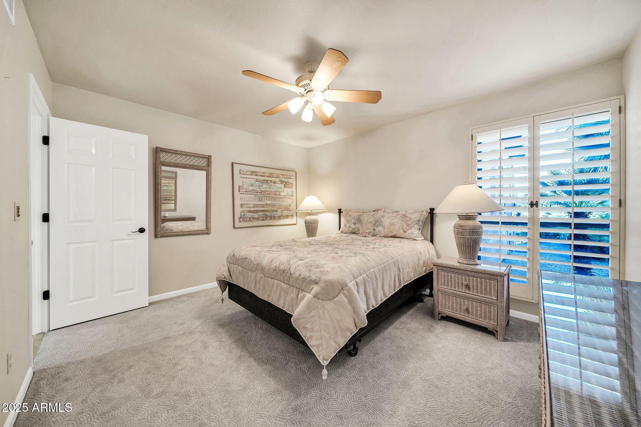 25515 Forest Road, Unit 13 Rio Verde, AZ 85263 - Photo 25 of 37 a bedroom with a bed and a chandelier