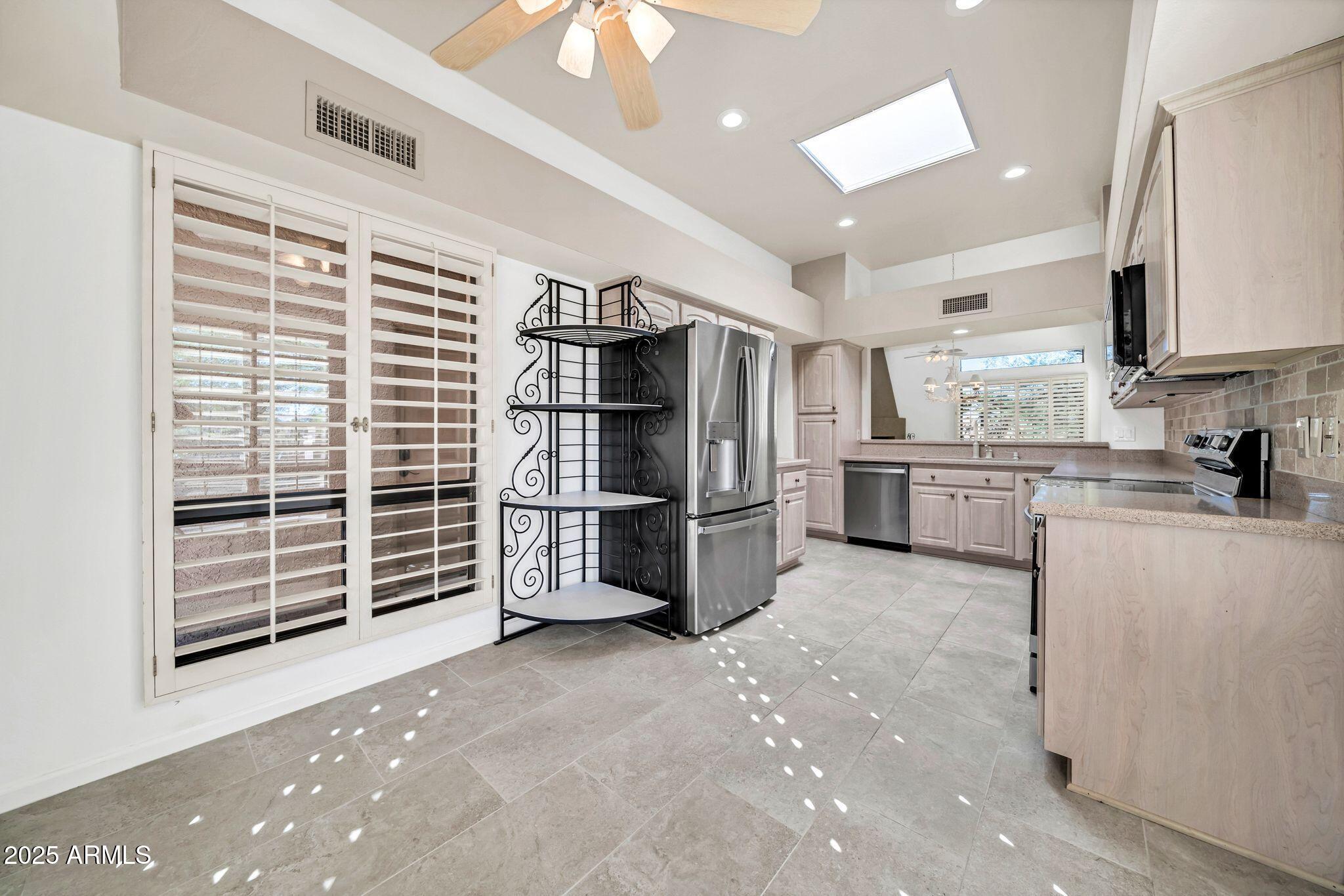 25515 Forest Road, Unit 13 Rio Verde, AZ 85263 - Photo 9 of 37 a kitchen with stainless steel appliances a refrigerator and a stove top oven