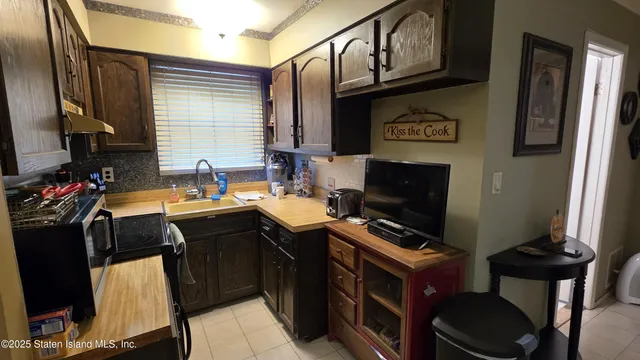 a kitchen with a sink appliances and cabinets