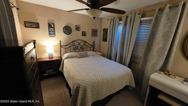 a bedroom with a bed and a table with wooden floor