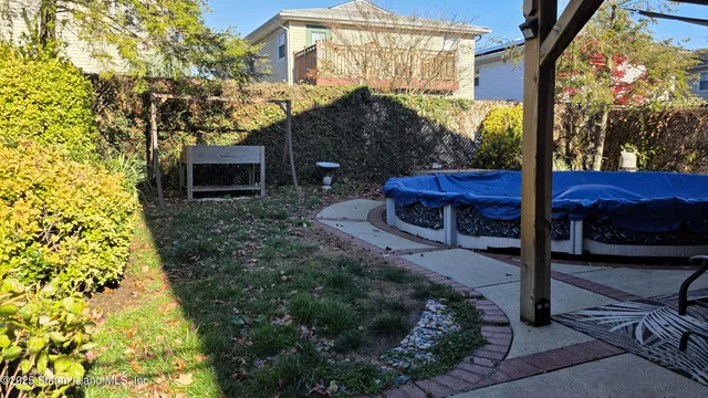 a view of a porch with furniture and a yard