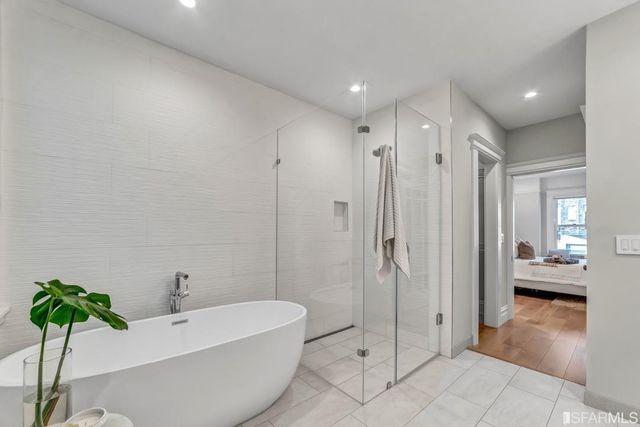 a kitchen with stainless steel appliances a stove a refrigerator and a sink