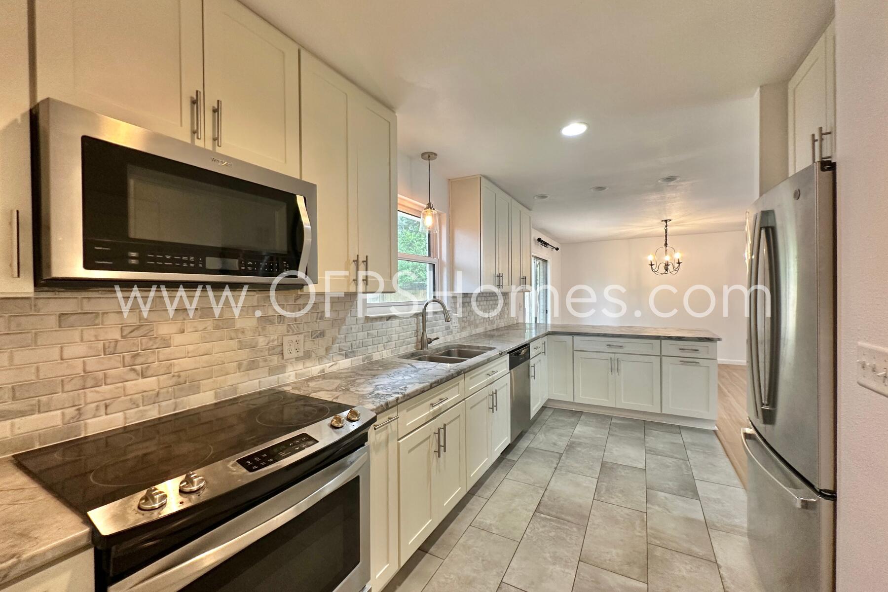 309 Pontevedra Lane Niceville, FL 32578 - Photo 12 of 32 a kitchen with a sink stove and microwave