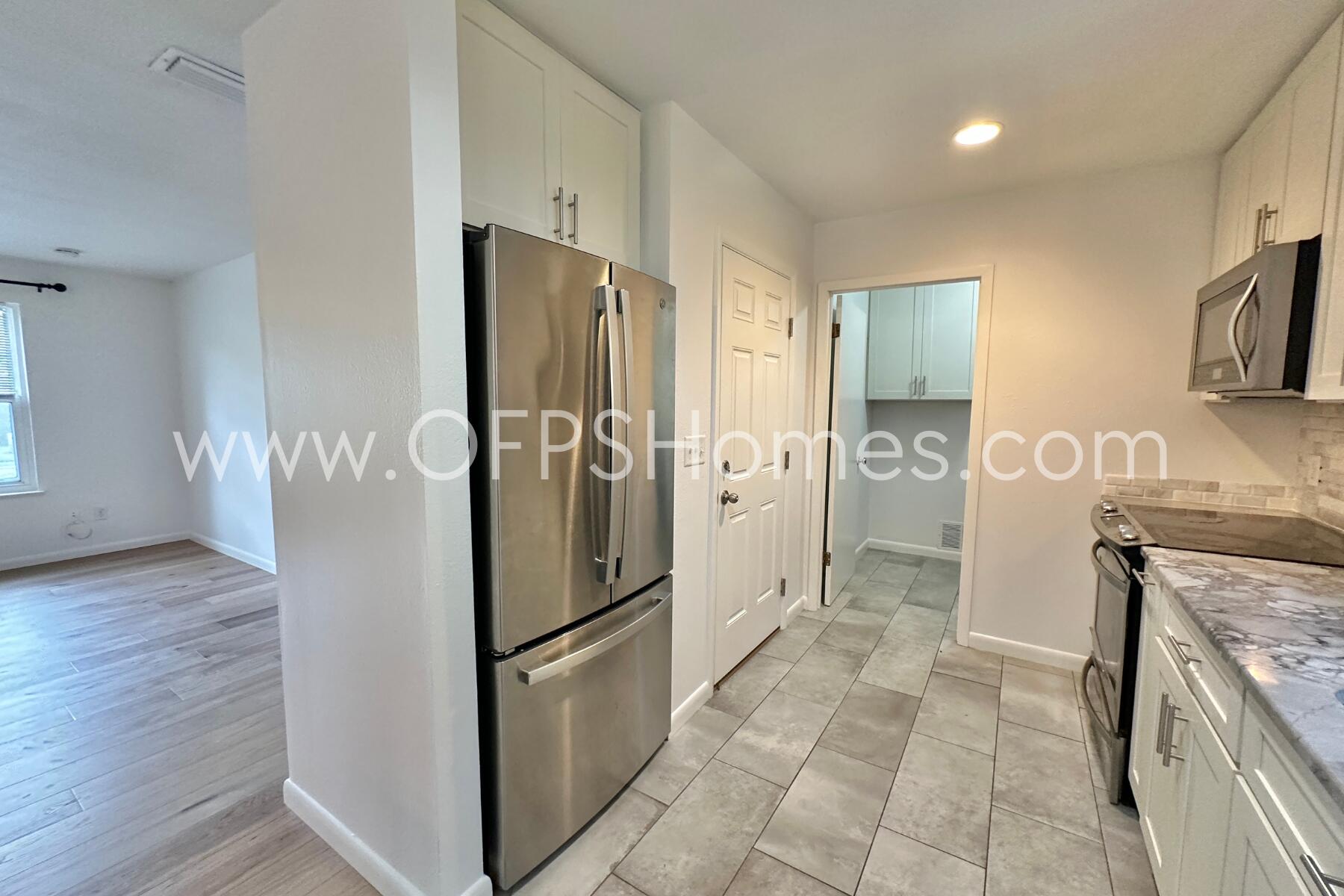 309 Pontevedra Lane Niceville, FL 32578 - Photo 14 of 32 a kitchen with stainless steel appliances granite countertop a refrigerator and a stove