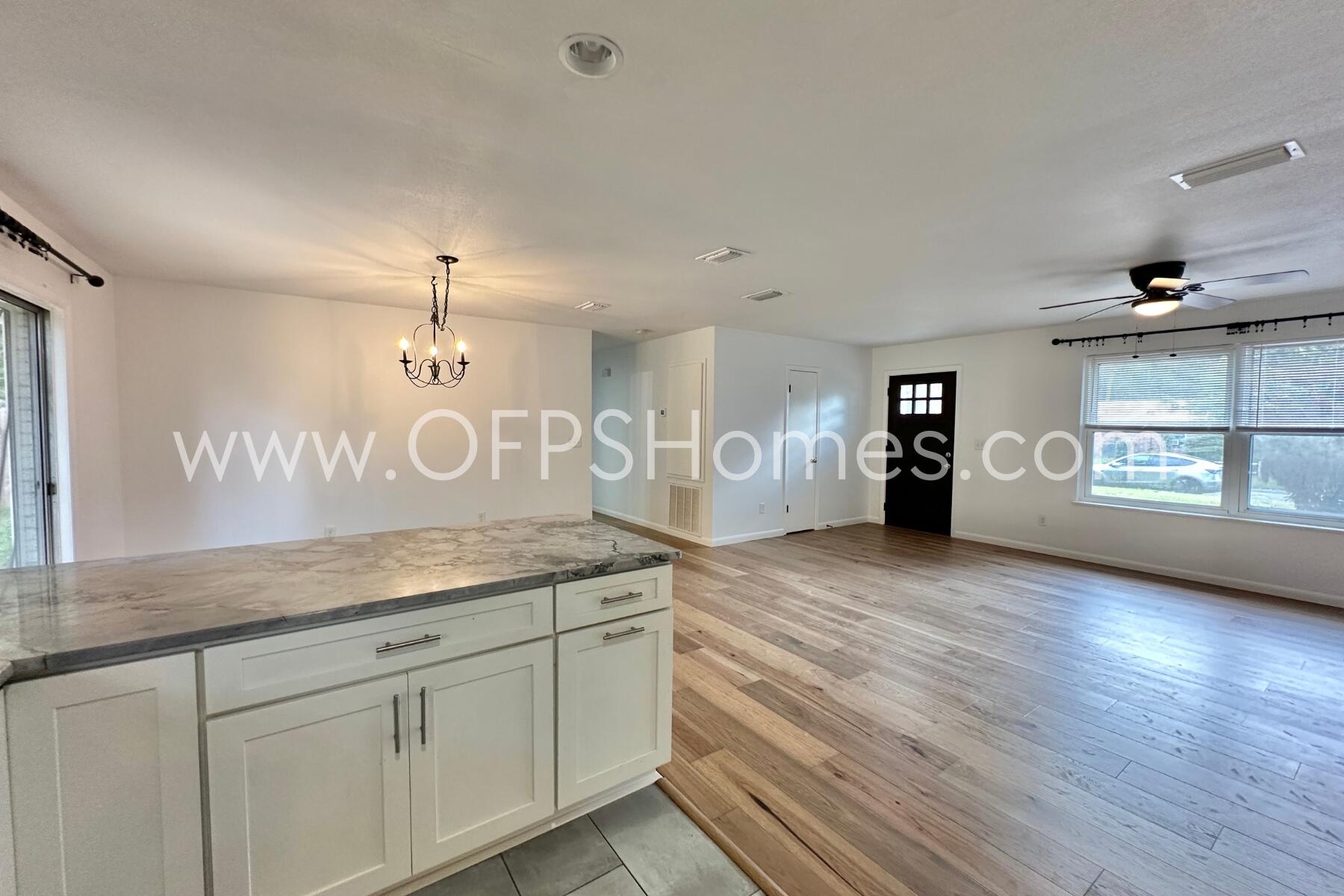 309 Pontevedra Lane Niceville, FL 32578 - Photo 16 of 32 a view of a kitchen counter space a stove and wooden floor