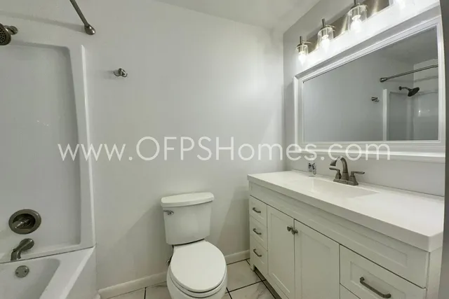 a bathroom with a shower and a toilet