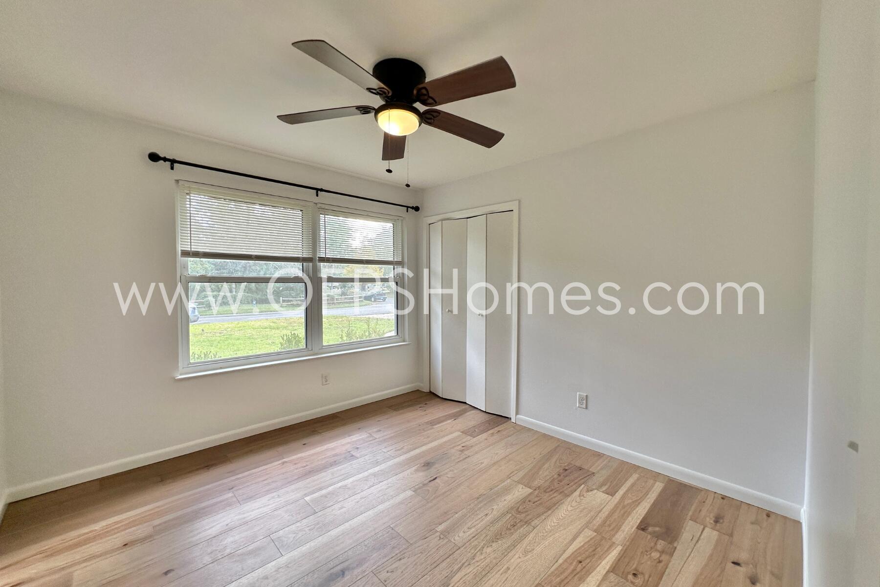 309 Pontevedra Lane Niceville, FL 32578 - Photo 20 of 32 an empty room with wooden floor fan and windows