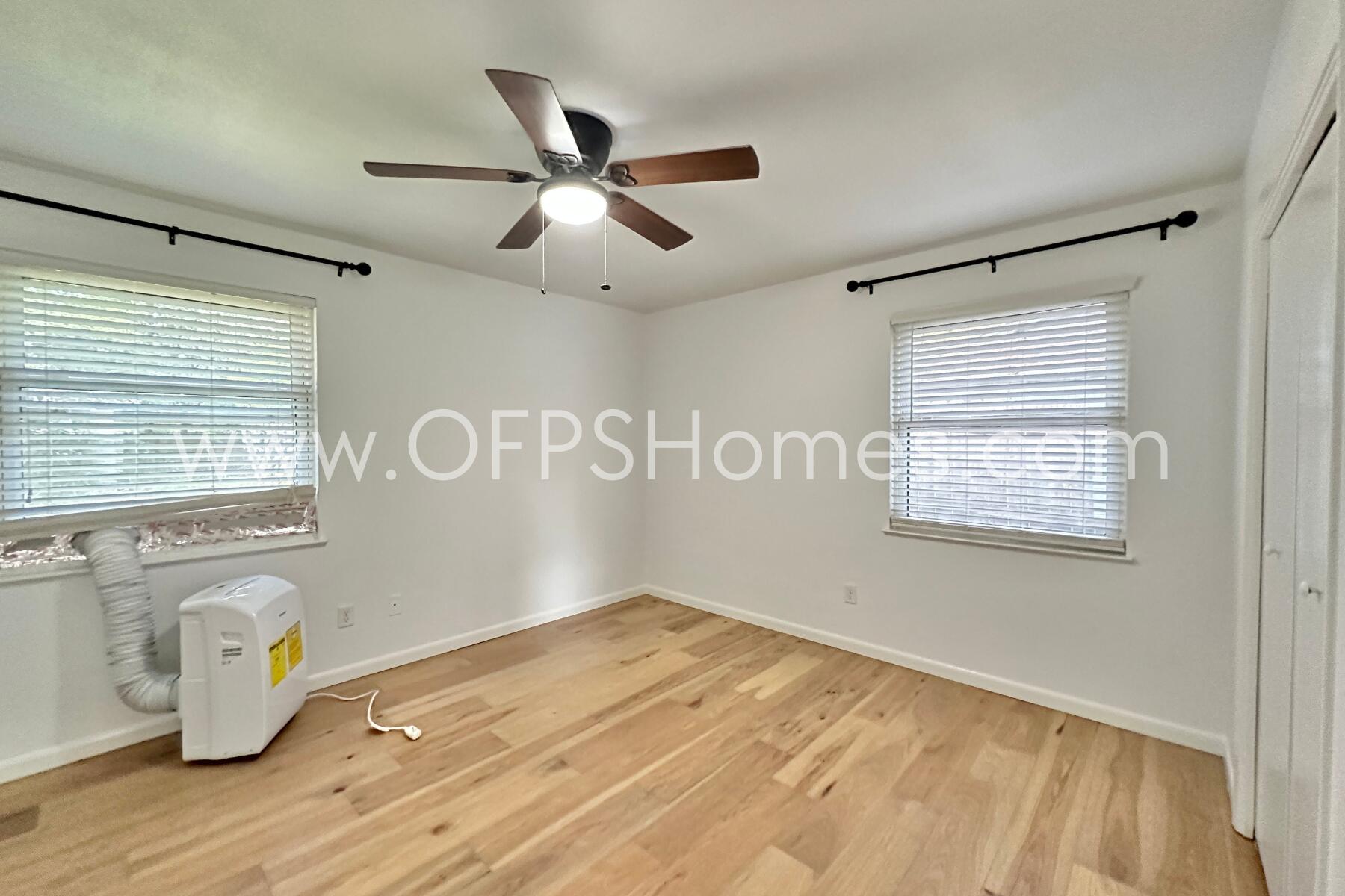 309 Pontevedra Lane Niceville, FL 32578 - Photo 24 of 32 a view of empty room with wooden floor and fan