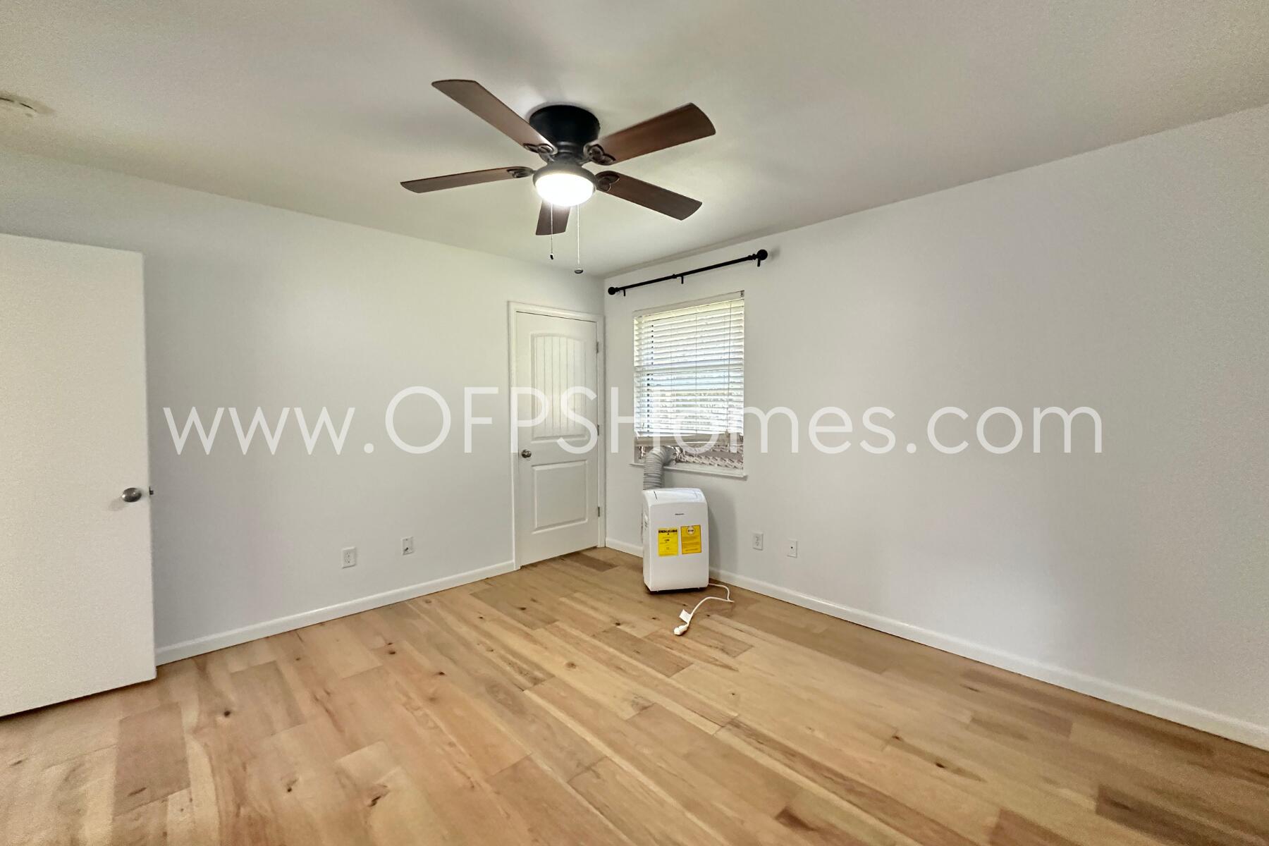 309 Pontevedra Lane Niceville, FL 32578 - Photo 25 of 32 a view of a livingroom with a chandelier fan and wooden floor
