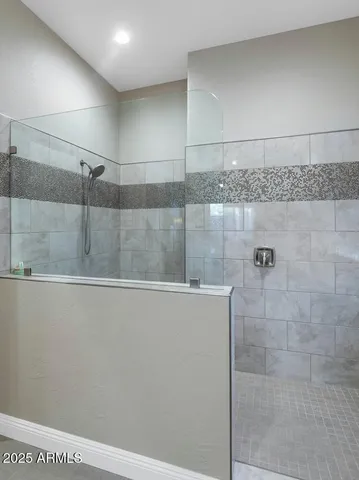 a bathroom with a granite countertop sink a toilet a mirror and shower