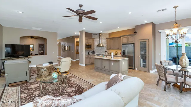 a kitchen with stainless steel appliances granite countertop a sink refrigerator and cabinets
