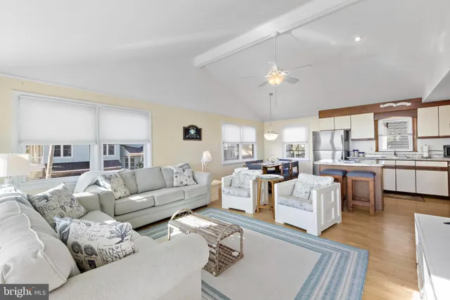 a living room with stainless steel appliances kitchen island granite countertop furniture and a kitchen view