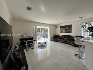 West Kendall Miami, FL 33193 - Photo 11 of 25 a living room with furniture and a flat screen tv