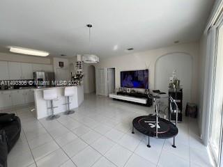 West Kendall Miami, FL 33193 - Photo 12 of 25 a kitchen with stainless steel appliances kitchen island granite countertop a sink and a white cabinets