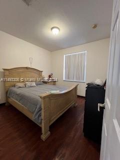 West Kendall Miami, FL 33193 - Photo 16 of 25 a bedroom with a bed and wooden floor