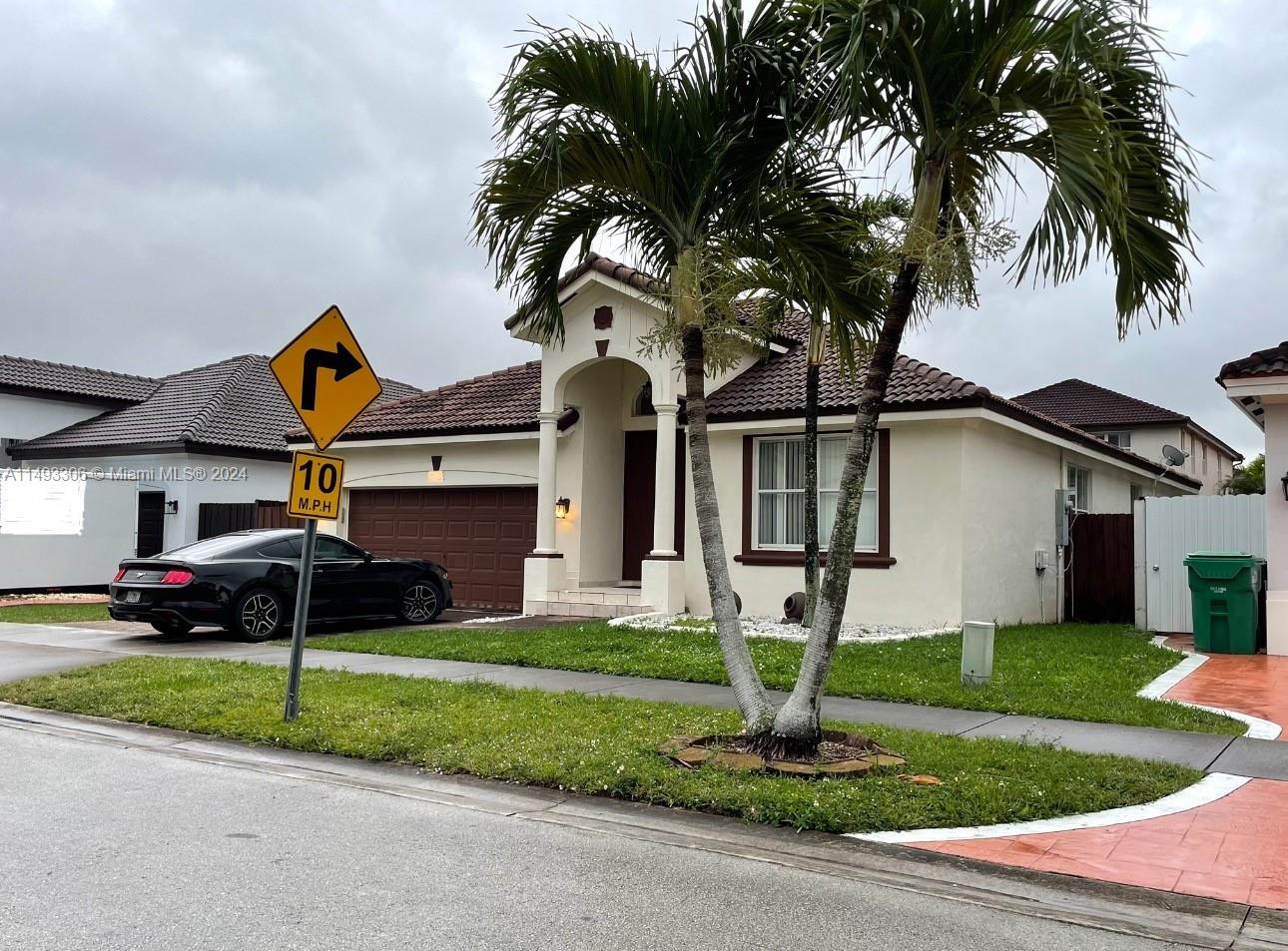 West Kendall Miami, FL 33193 - Photo 2 of 25 a front view of a house with a yard and garage