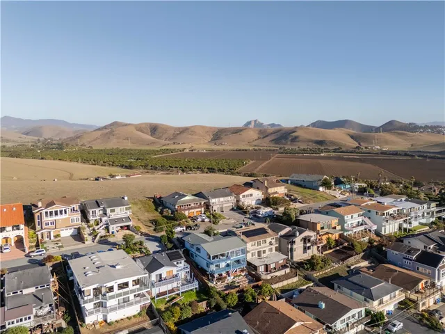 an aerial view of a city with mountains