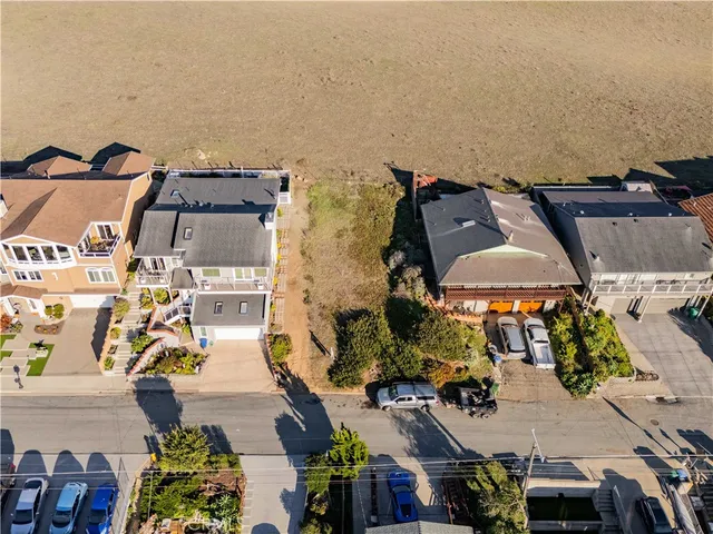 an aerial view of multiple houses with yard