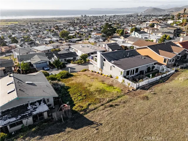 an aerial view of residential houses with city view