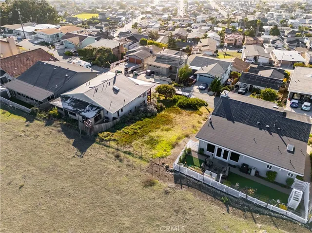 an aerial view of a house with a yard basket ball court and outdoor seating