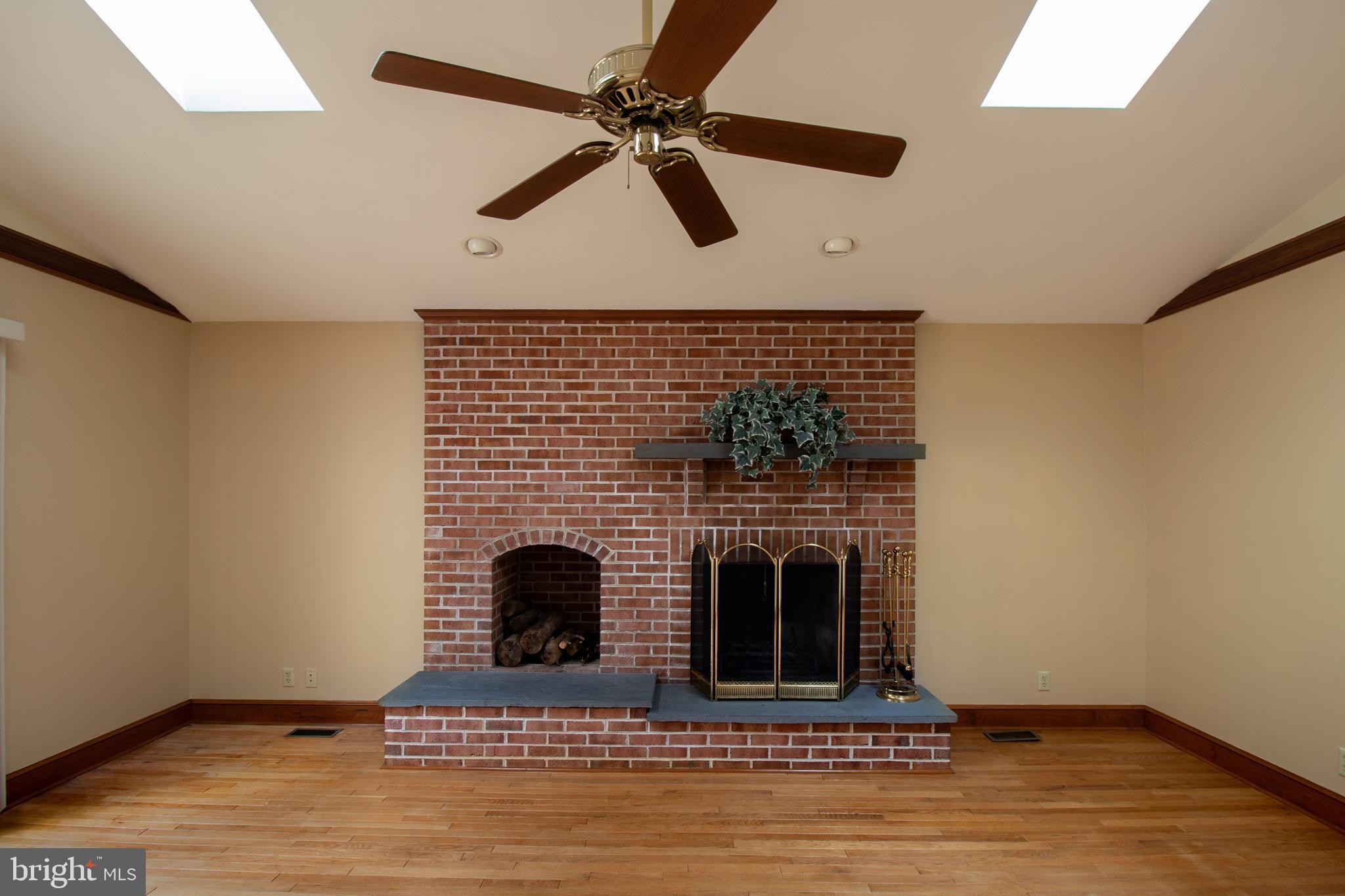 7782 Poplar Grove Road Severn, MD 21144 - Photo 13 of 52 Built in log holder, hardwood floor