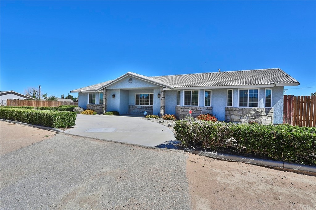 20172 Sahale Road Apple Valley, CA 92307 - Photo 1 of 1 a front view of a house with a garden