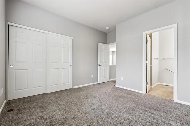 a view of an empty room and closet area