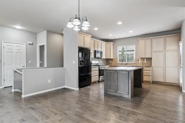 a kitchen with a refrigerator and a sink