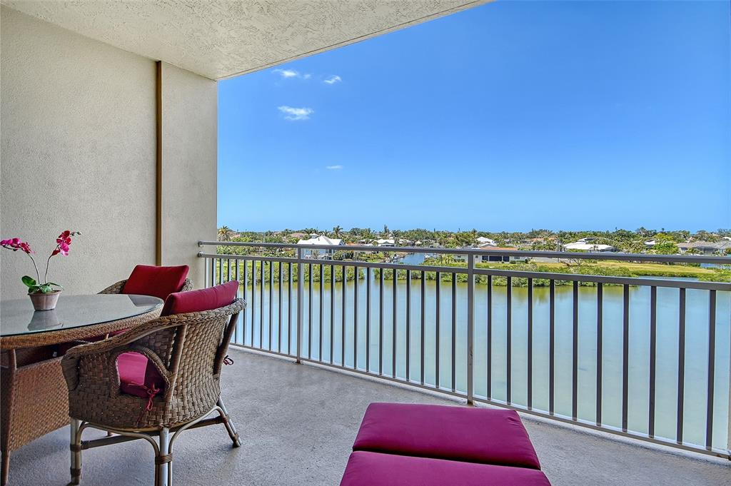 a balcony with a table and chairs