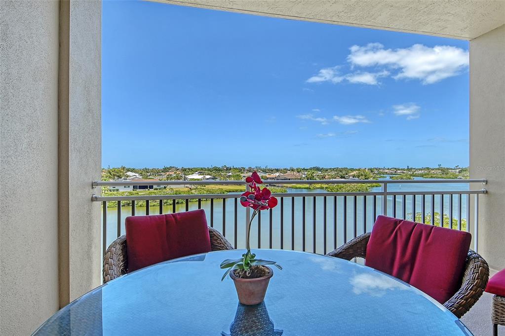 5100 Jessie Harbor Drive, Unit 504 Osprey, FL 34229 - Photo 11 of 87 a balcony with table and chairs