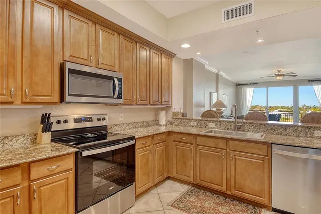 a bathroom with a granite countertop double vanity sink and a mirror